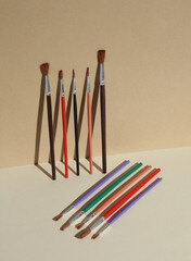 Set of paint brushes on a beige background. Children's creativity