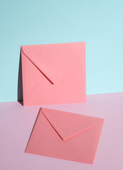 Pink square paper envelopes on pastel background