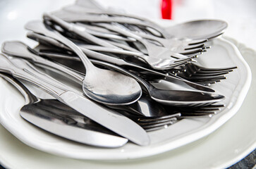 a set of silver cutlery knives, forks and spoons for the holidays