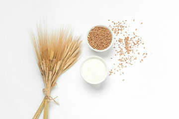 Wheat Spikelets, Bowl with wheat grains and flour on white background