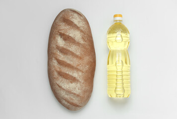 Bread and a bottle of sunflower oil on a white background. Humanitarian assistance