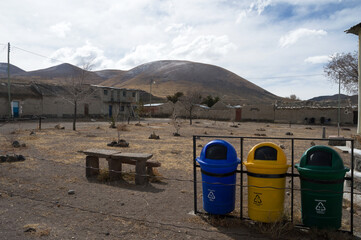 Selective garbage collection drums in a small square in a remote village called Jirira in Bolivia