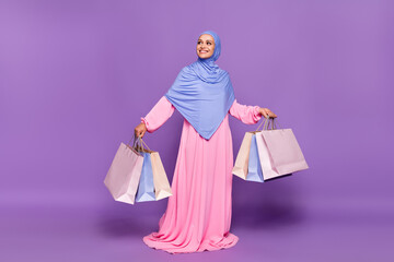 Full size photo of lovely young lady with shoppers look ramadan holiday wearing blue hijab muslim...