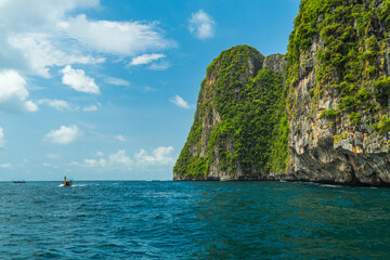 Krabi, Thailand - May 12 2022 : Long-tailed boats are taking tourists travel to see the view of Phi...