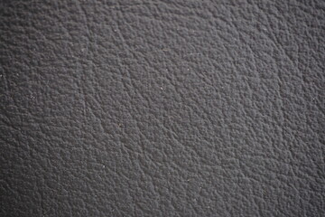 Car seat black natural leather texture extreme close-up
