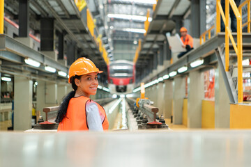 Portrait of a young female engineer standing in the skytrain repair station.