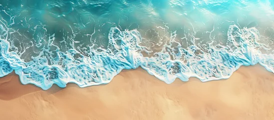 Fototapeten Aerial view of electric blue waves crashing on sandy beach © Jahid