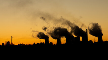 Fototapeta premium Coal power plant silhouette at sunrise, South Africa