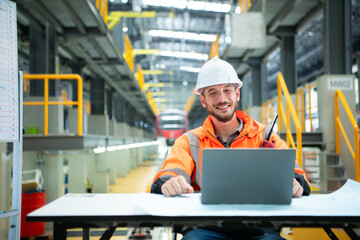 Portrait of Young male technician sitting on the table in skytrain repair station, Check the...
