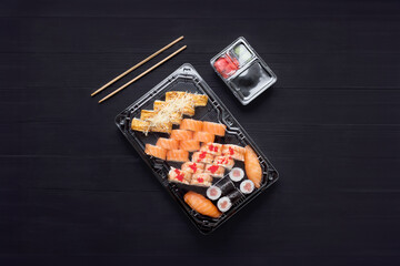 Sushi set with salmon on a black background, top view