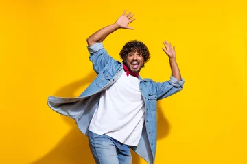 Store enrouleur Magasin de musique Photo portrait of nice young male raise hands excited dance dressed stylish denim outfit red scarf isolated on yellow color background