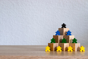 Colorful figures on wooden block pyramid