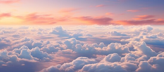 Witness the breathtaking view of cumulus clouds floating in the sky at sunset, creating a mesmerizing natural landscape against the afterglow of dusk - obrazy, fototapety, plakaty