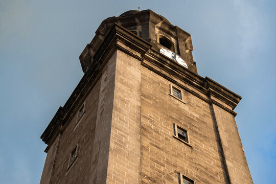 The historic clock tower of the Manila Cathedral under beautiful blue sky.
