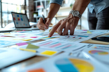 Marketing team collaboratively brainstorming over colorful sticky notes on a whiteboard in a creative office.