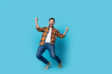 Full length photo of nice young guy raise fists celebrate big luck wear trendy plaid garment...