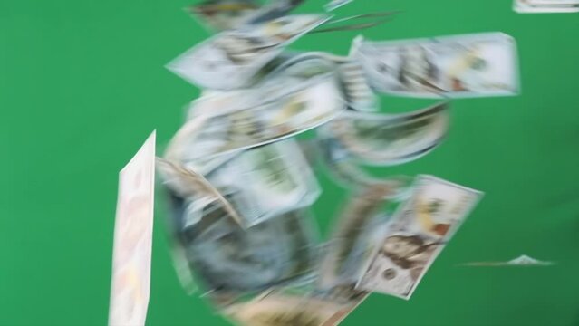 US hundred dollars banknotes scatter across on green screen background, tax refund celebration.