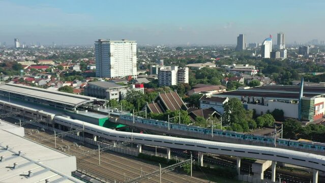 Jakarta City Train Station and Train. Cityscape in Background. Indonesia