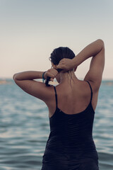 A young beautiful girl posing in the water on the sea beach