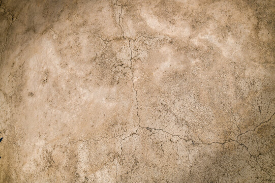 Texture of a brick wall with white shabby plaster, plaster. background, surface of a stone wall. Plastered wall with uneven plaster with cracks and damage. 1