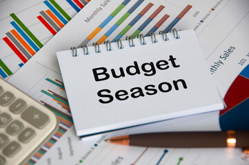 Budget season text on notepad with business analysis background