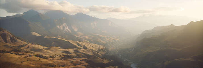 Mountain valley bathed in the warm light of sunset. Play of light and shadow accentuates the rugged...