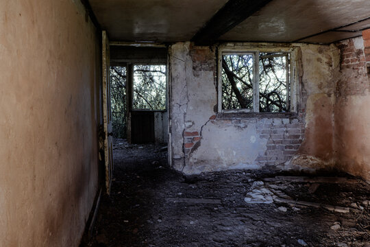 Inside a spooky eerie ruined abandoned house. With broken windows and doors in the countryside