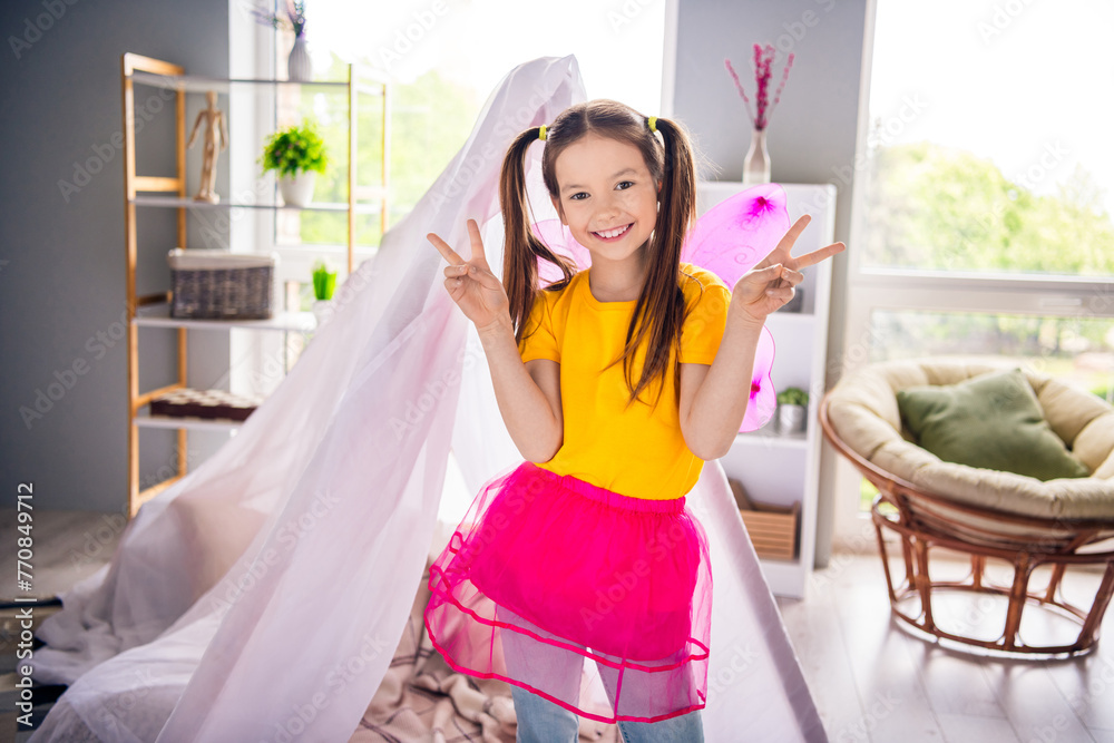 Sticker Photo portrait of adorable small girl fairy costume playtime show v-sign dressed stylish yellow garment preschoolers kindergarten interior