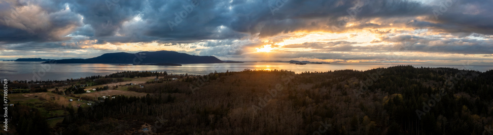 Wall mural Panoramic aerial sunset over Orcas Island with dramatic clouds. Seen from Lummi Island and looking across Rosario Strait in the San Juan Islands area of western Washington state. 