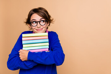 Photo of creative minded lady hold pile stack book look empty space brainstorming isolated on beige color background