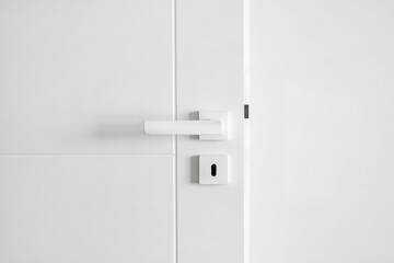Design of modern door with metal handle and keyhole on white background