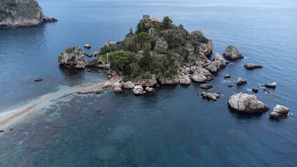 Panoramic view of beautiful Isola Bella, small island near Taormina, Sicily, Italy. Narrow path connects island to mainland Taormina beach surrounded by azure waters of Ionian Sea. - 770872703