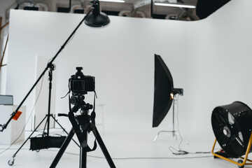 photo studio with digital photo camera, lighting equipment and fan