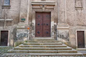 Old decorative entrance wooden door with steps