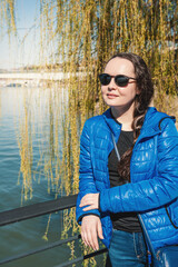 Beautiful woman with sunglasses against Sava river in Belgrade, Serbia