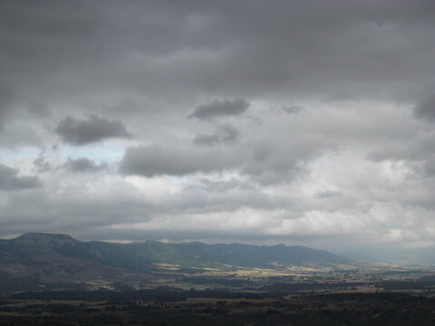 cantabrian mountain range on a cloudy rainy day  and green fields
