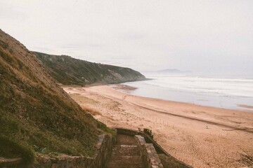 Fototapeta na wymiar view of the coast of the atlantic ocean from sopelana beach with the stairs full shot eye level
