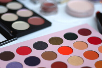 Various colorful beauty products on white background. Selective focus.