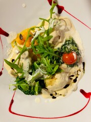 bread dumplings with mushroom cream sauce and arugula salad