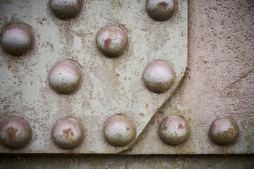 Close-Up of Riveted Steel Plates, Textured Metal Background with Rust and Patina