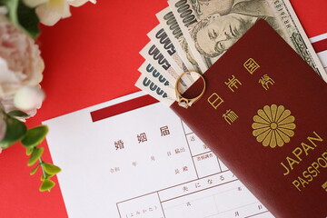 Japanese marriage registration blank document and wedding proposition ring and yen money on table close up