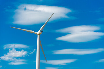 Wind turbine on a filed, wind farm generating electrical energy