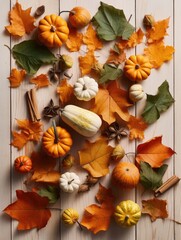 Variety of pumpkins, gourds of different sizes arranged on rustic wooden table covered with fall leaves, cinnamon sticks.