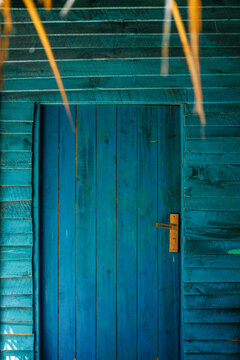 Blue wooden door with yellow lock.