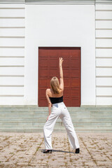 Full length portrait of a young girl in white pants