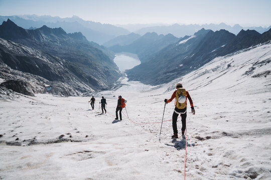 A roped party on a glacier trekking in the Alps.
