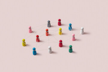 Multicolor game pawns connected by thread.