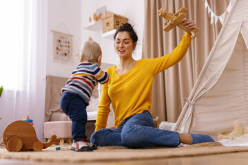 Joint play between mother and son in children's room