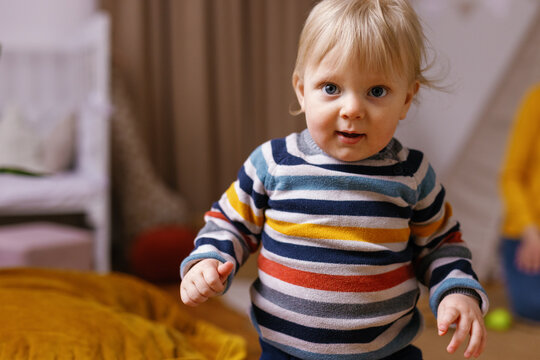 Smiling baby striped sweater captures hearts