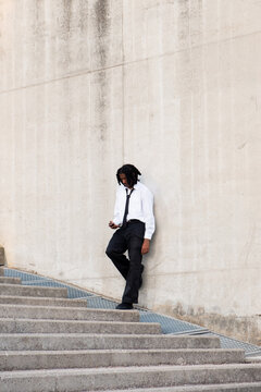 Black man with braids wearing suit and tie